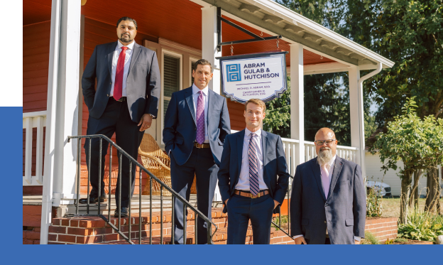 The team at Abram, Gulab & Hutchison outside on a set of stairs